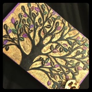 Wooden box with a tree on it, has some color.